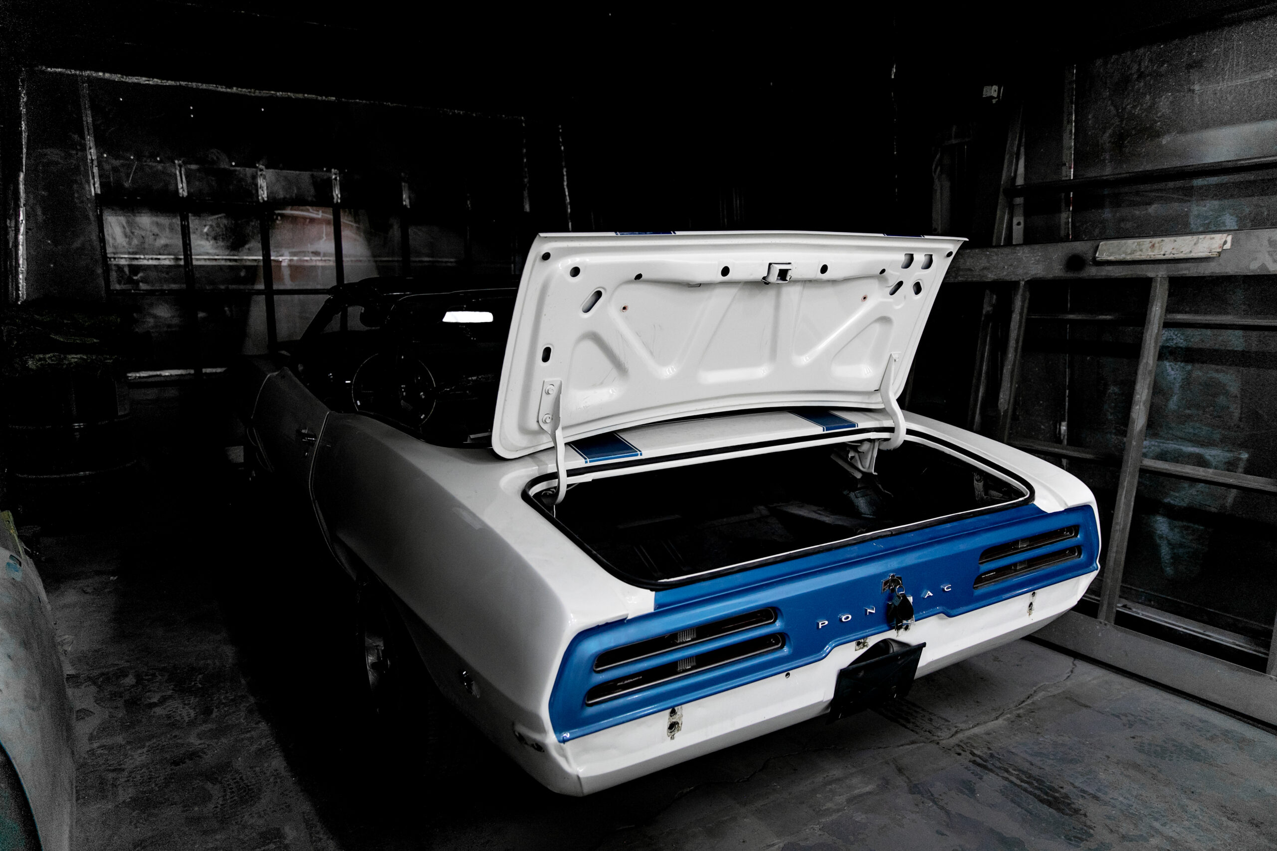 White and blue Pontiac inside the Bernelis Garage workshop